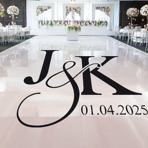 May include: A black and white wedding dance floor decal with the initials "J&K" and the date "01.04.2025".