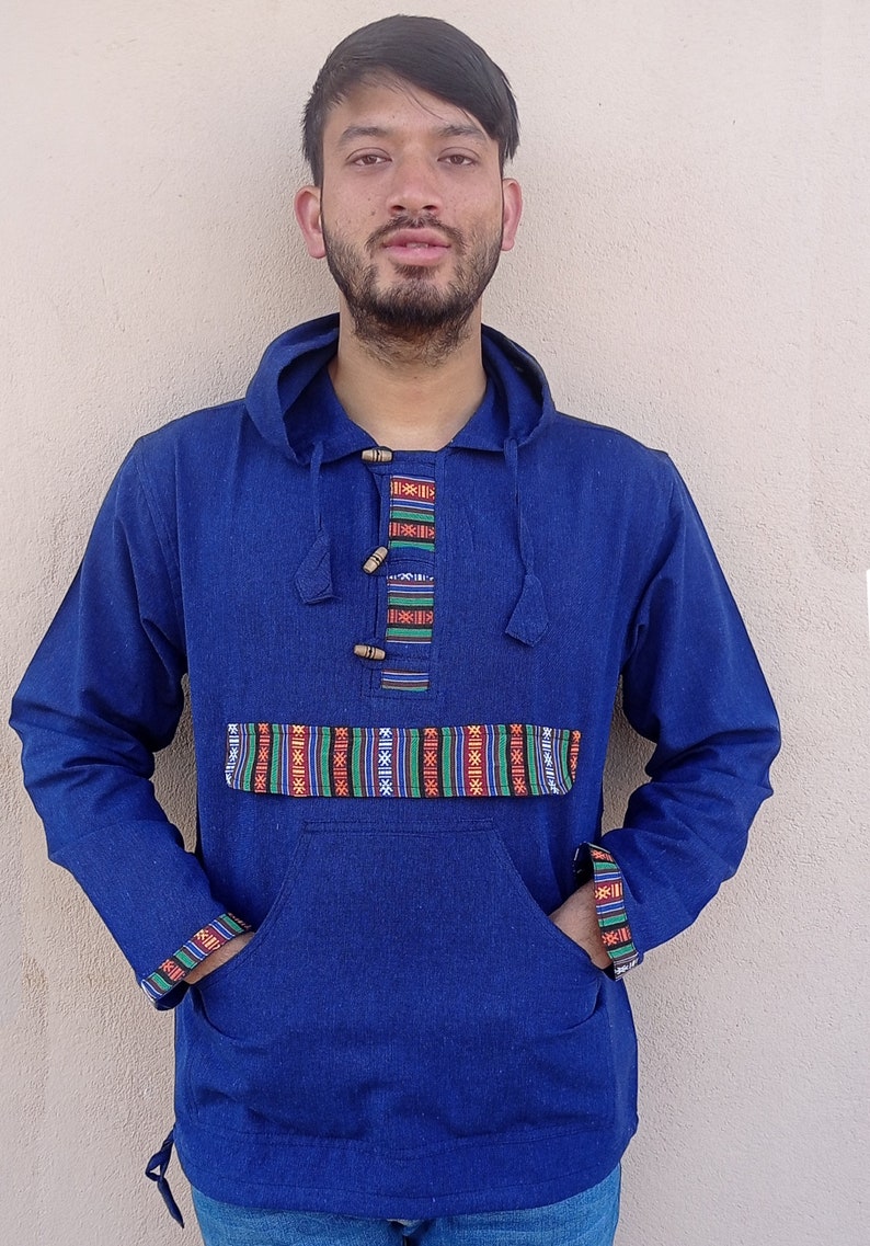 May include: A blue hooded sweatshirt with a colorful patterned trim around the neck, pockets, and cuffs. The sweatshirt has a drawstring hood and wooden button closures.