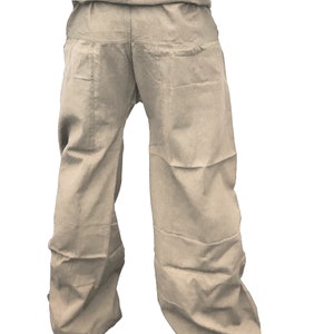 May include: A pair of beige cotton pants with a wide leg and a gathered waistband.