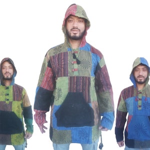 May include: Three men wearing colourful patchwork hooded shirts with a black pocket on the front. The shirts have a variety of patterns and colours, including green, blue, red, and brown.