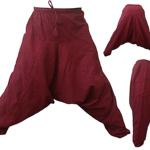 May include: Burgundy red cotton trousers with a loose, baggy fit and a drawstring waist.