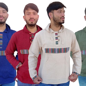 May include: Four hooded shirts in different colors: blue, red, beige, and green. Each shirt has a decorative band of colorful stripes across the chest and a row of wooden buttons down the front.