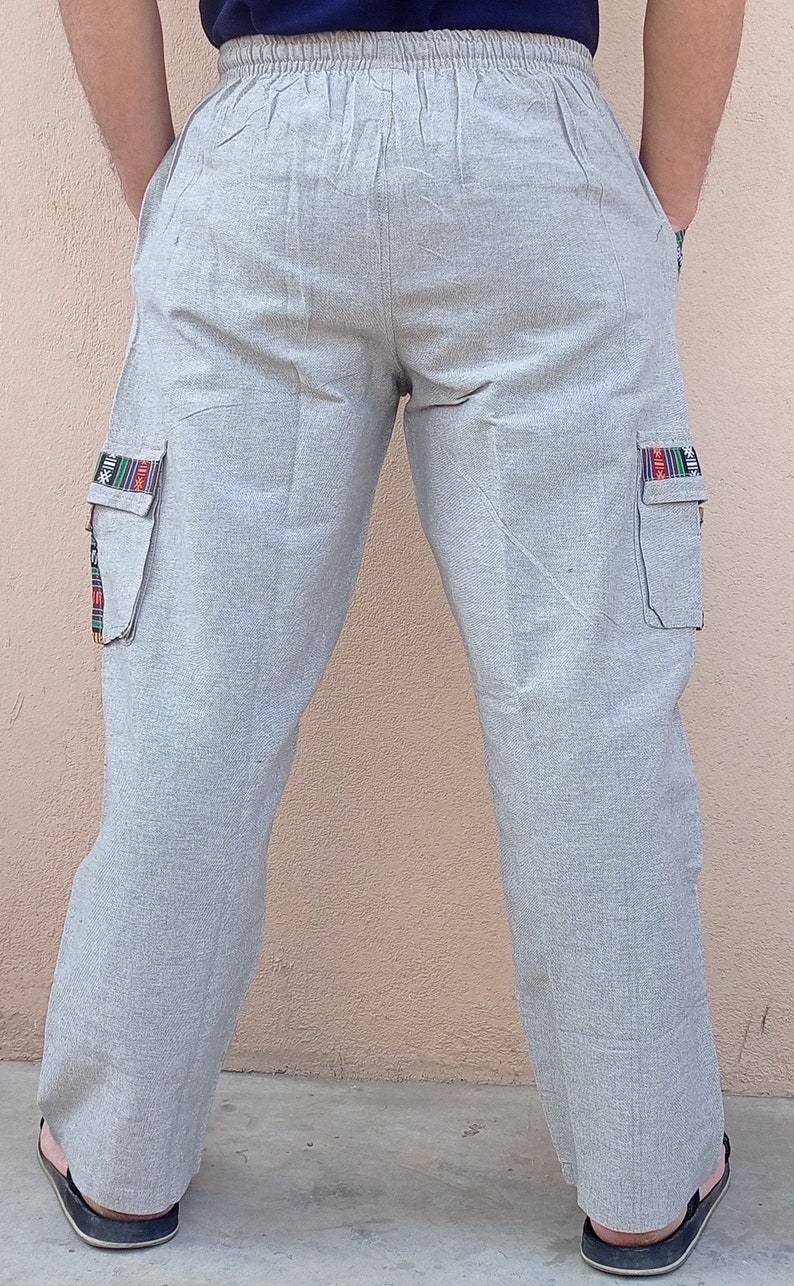May include: Gray cargo pants with a drawstring waist and colorful trim on the pockets.