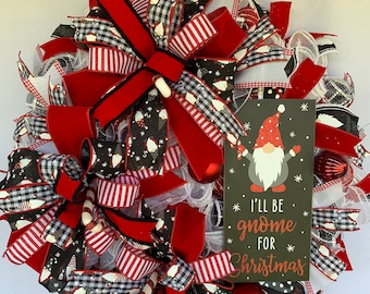 May include: A Christmas wreath with red, white, and black plaid ribbon, red velvet ribbon, and a sign that says "I'll be gnome for Christmas".