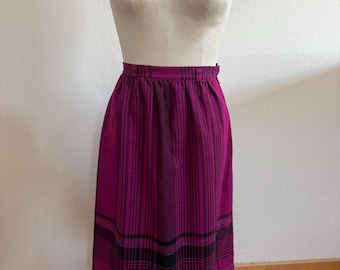 May include: A pink and black plaid skirt with a high waist and a gathered skirt. The skirt is made of a thick, woven fabric.