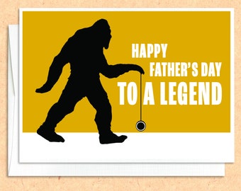 May include: A yellow card with a black silhouette of a Bigfoot holding a yo-yo. The card says "Happy Father's Day to a Legend".