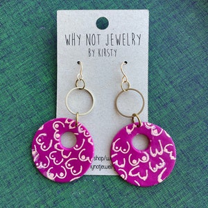 Big circular purple boob earrings!