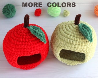 May include: Two crocheted apple-shaped pet beds, one red and one green, with a small green crocheted leaf on top of each.  The beds have a hole in the side for entry.