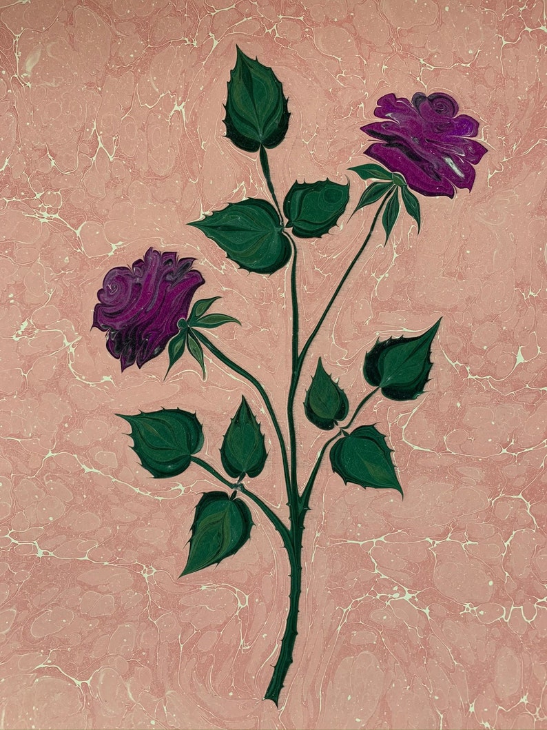 May include: A painting of two purple roses with green leaves and stems on a pink background with white marbling.