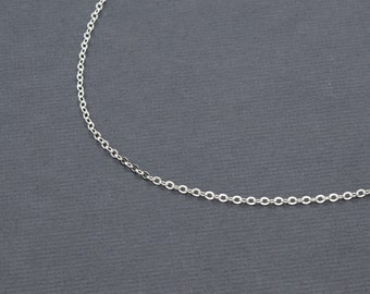 May include: A silver chain necklace with a delicate, fine link design.