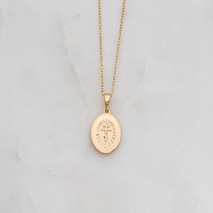 May include: A gold chain necklace with a pendant featuring a cross inside a circle.