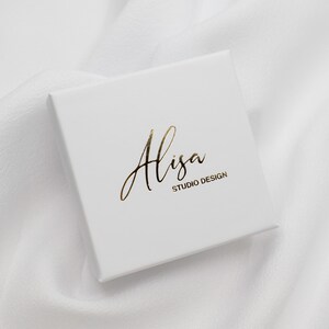 May include: White box with gold lettering that reads "Alisa Studio Design".