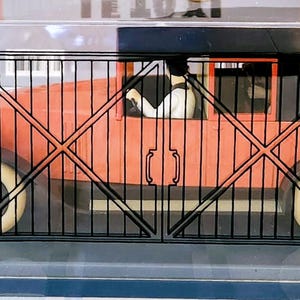 May include: A set of three ceramic mugs with a speckled, cream-colored glaze. Each mug features a different hand-painted design: a blue and green leaf, a yellow flower, and a red berry. The mugs have a simple, rounded shape.