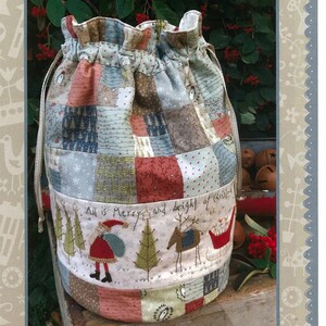 May include: A patchwork drawstring bag with a Christmas theme. The bag features a mix of fabrics in various colors and patterns. The bottom band displays a festive scene with Santa, trees, and reindeer. Text on the bag reads "All is Merry & Bright".