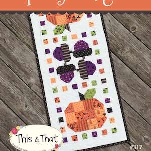 May include: A quilting pattern for a table runner featuring a Halloween theme with pumpkins, bats, and ghosts. The pattern is called "Spooky Delight" and is from the "This & That" collection by Sherri K. Falls. The pattern number is #317.