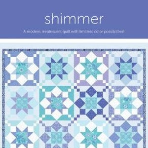 May include: A quilt pattern called "Shimmer" featuring a modern, iridescent quilt with limitless color possibilities. The quilt is made up of a grid of 16 squares, each with a different star-shaped design in shades of blue, purple, and white.