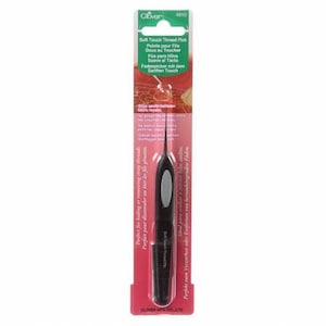 May include: A black plastic thread pick with a soft touch tip. The packaging shows the product name "Soft Touch Thread Pick" and the brand name "Clover".