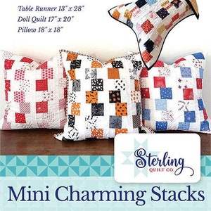 May include: A quilting pattern for a table runner, doll quilt, and pillow. The pattern uses a mini charm pack and features a white background with colorful squares. The pattern is called "Mini Charming Stacks" and is by Sterling Quilt Co.