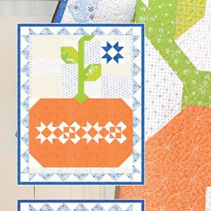 May include: A quilting pattern for a pumpkin-themed wall hanging or topper. The pattern features a simple design with a pumpkin and leaves in orange, green, and blue colors. The text "Pumpkin & Denim" and "Simple Sew & Flip Seasonal Wall Hanging-Or-Topper" is visible on the pattern.
