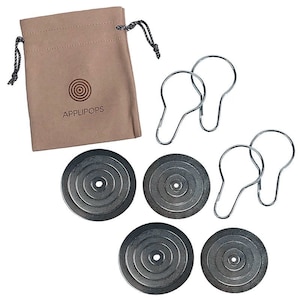 May include: Set of four silver metal discs with concentric circles and a small hole in the center, along with four silver shower curtain rings. The discs are packaged in a brown fabric bag with the text "APPLIPOPS" printed on it.