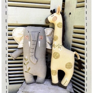 May include: A handmade stuffed elephant and giraffe toy set. The elephant is gray with a brown trunk and ears. The giraffe is tan with brown spots and a brown tail. The toys are 13 inches and 18 inches tall, respectively. #403 Jungle Friends - Elephant & Giraffe - Heart to Hand