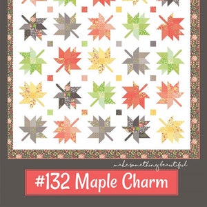 May include: A quilt pattern featuring a white background with a repeating pattern of colorful maple leaves. The quilt pattern is titled "#132 Maple Charm" and is from "Coriander Quilts by Corey Yoder".