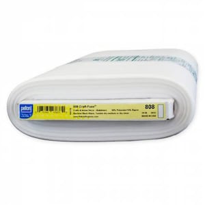May include: A roll of white Pellon 808 Craft-Fuse fabric. The label shows the product name, care instructions, and a barcode. The fabric is 20 inches wide and made in the USA. The label is yellow and blue.