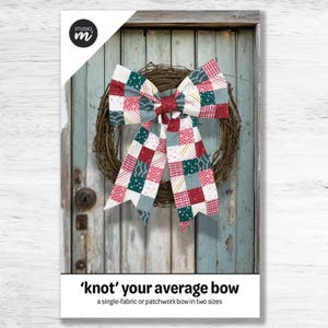 May include: A colorful patchwork bow with red, pink, green, and white squares is displayed on a grapevine wreath. The bow is the focal point, set against a weathered, light blue wooden door. The text reads "'knot' your average bow".