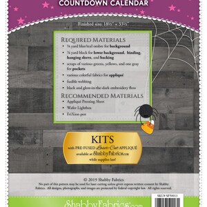 May include: Halloween Countdown Calendar sewing pattern with a spider and candy corn graphic. The pattern includes instructions for a 18 1/2 by 33 1/2 inch calendar, required materials, and recommended materials. The pattern is available as a pre-fused laser cut appliqu&eacute; kit.