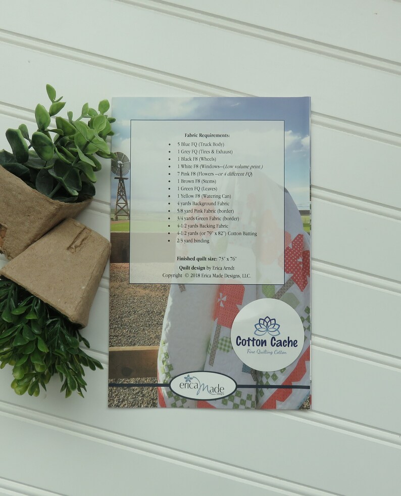 May include: A printed fabric pattern guide for a quilt design called "Cotton Cache" by Erica Amdt. The guide lists the fabric requirements for the quilt, including the colors and quantities of fabric needed. The finished quilt size is 75 inches by 76 inches.