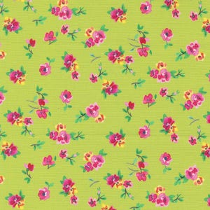 May include: A green fabric with a repeating pattern of small pink and yellow flowers. The flowers are scattered randomly across the fabric.