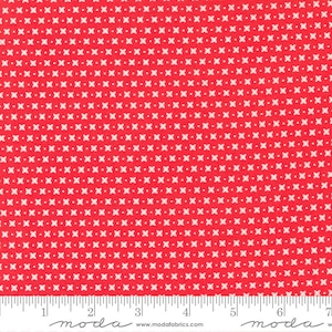 May include: Red fabric with a white repeating pattern of small crosses. The fabric is measured with a ruler that reads "moda" at the 2-inch and 6-inch marks.