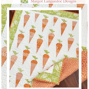May include: A quilt pattern featuring a white background with orange and green carrots. The quilt is folded in half and the fabric is visible on the back. The quilt is titled "Carrot Patch" and the website "www.thepatternbasket.com" is displayed below the title.
