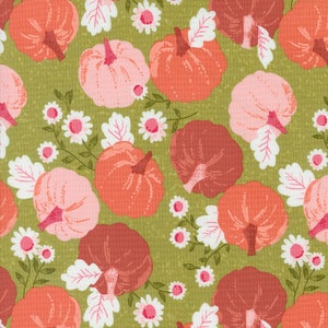 May include: A green fabric with a repeating pattern of pink, orange, and red pumpkins with white leaves and white flowers.
