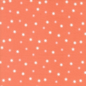 May include: Coral fabric with a repeating pattern of white starbursts. The stars are evenly spaced across the fabric, creating a whimsical and playful design. The fabric has a textured appearance.