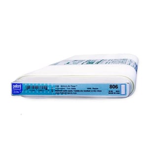 May include: A white roll of Pellon 806 Stitch-N-Tear Embroidery Tear Away fabric. The label reads: 806 Stitch-N-Tear Embroidery Tear Away 100% Rayon Machine wash warm. Tumble dry medium or dry clean. www.PellonProjects.com 20 in 2012 Made in USA.