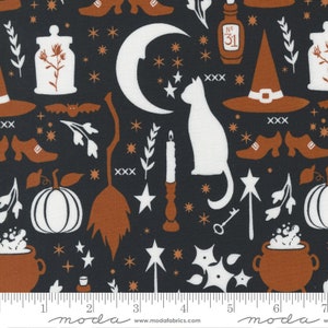 May include: A black fabric with a repeating pattern of white and orange Halloween themed illustrations. The illustrations include a crescent moon, a cat, a witch's hat, a broom, a cauldron, a pumpkin, a bottle, a candle, a key, a star, and a shoe. The fabric has a ruler printed on the bottom with the numbers 1 through 7.