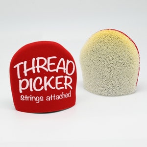 May include: Red thread picker with the words "THREAD PICKER" and "strings attached" in white lettering. The picker has a white foam tip.