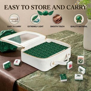 May include: A white rectangular carrying case with a clear top window, containing a set of green patterned Mahjong tiles. Several individual tiles with red, green, and black symbols are arranged around the case, which features a handle.
