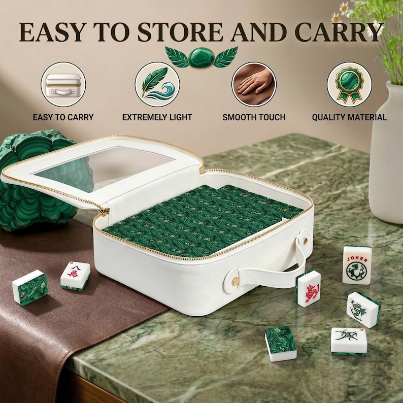 May include: A white rectangular carrying case with a clear top window, containing a set of green patterned Mahjong tiles. Several individual tiles with red, green, and black symbols are arranged around the case, which features a handle.