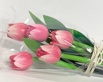 May include: A bouquet of pink wooden tulips wrapped in clear plastic with a twine bow.