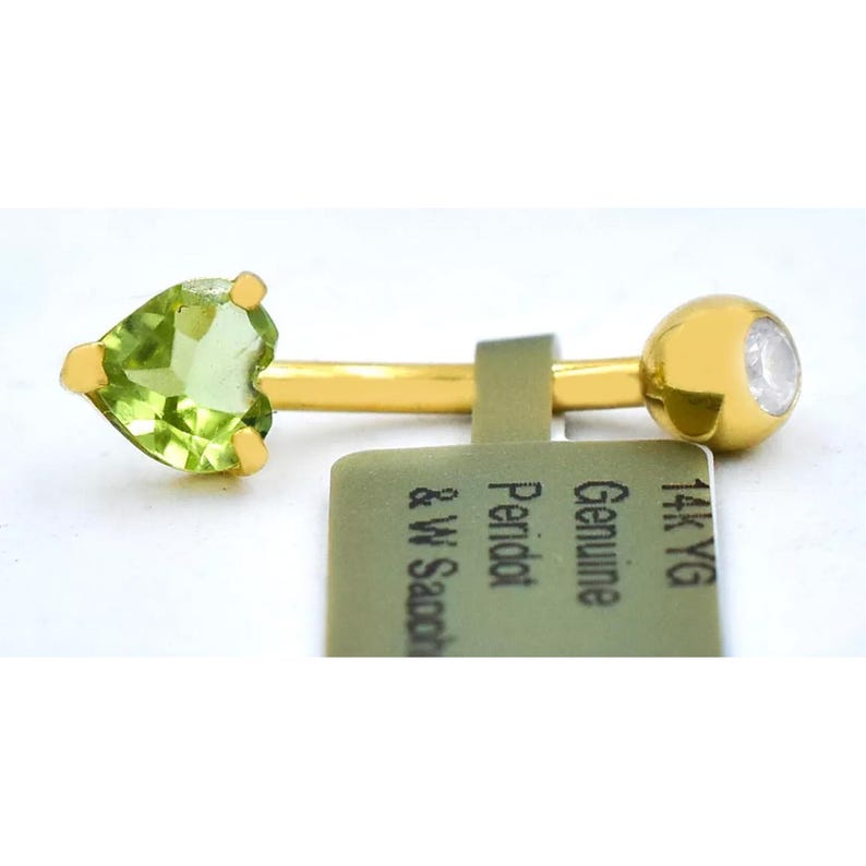 May include: A gold belly button ring with a heart-shaped peridot gemstone and a clear round stone on the end. The tag reads "Genuine Peridot & W. Sandor 14k YG".
