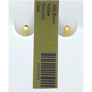 May include: A pair of small, gold-coloured hoop earrings. The earrings are displayed on a white background with a green tag that reads ".925 Silver Yellow Genuine Opal". The earrings have a simple, rectangular design.