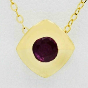 May include: A gold chain necklace with a square pendant featuring a round, dark purple gemstone.