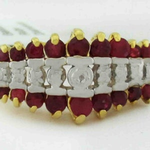 May include: A gold ring with a row of red rubies and a row of diamonds.