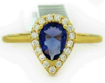 May include: A gold ring with a pear-shaped blue gemstone surrounded by a halo of smaller white gemstones.