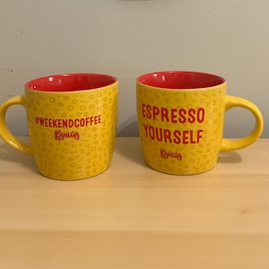May include: A set of three ceramic mugs with a speckled, matte finish in cream, light grey, and dark grey. Each mug has a simple, minimalist design, suitable for coffee or tea.