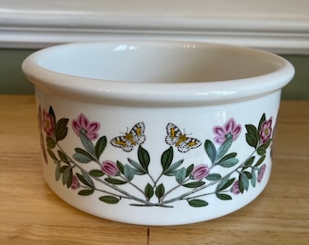 May include: White ceramic bowl with a floral design featuring pink flowers, green leaves, and butterflies with yellow and black wings.