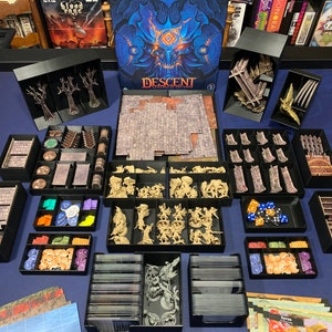 May include: A black and white organizer system for the board game Descent: Journeys in the Dark, Second Edition. The organizer includes compartments for the game's tiles, miniatures, cards, and dice. The organizer is made of high-quality materials and is designed to keep your game organized and easy to play.