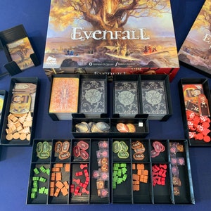 May include: A black organizer insert for the board game Evenfall. The insert has compartments for cards, tokens, and other game components. The insert is made of high-quality plastic and is designed to fit perfectly in the Evenfall game box.